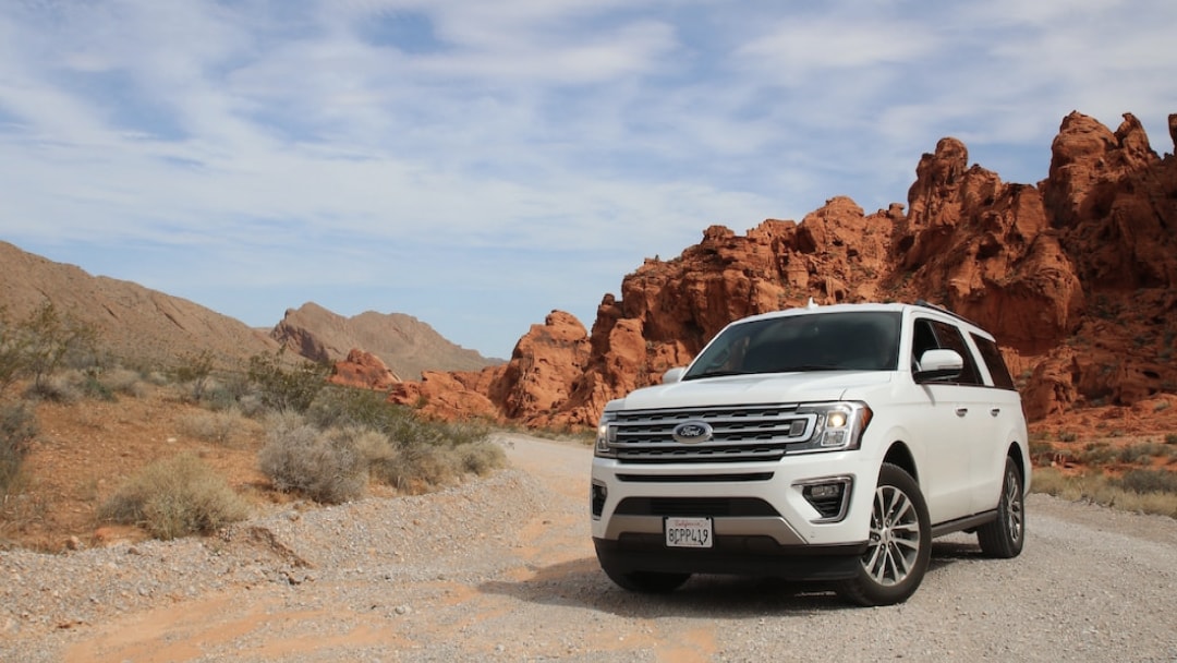 A white car parked in the wilderness